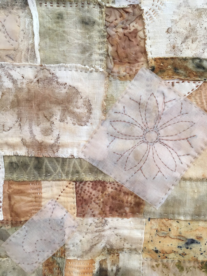 A neutral-toned crazy patchwork quilt